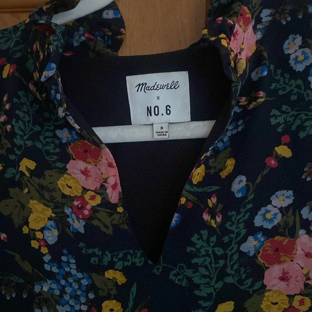 Sleeveless silk floral dress with lining. Black background.